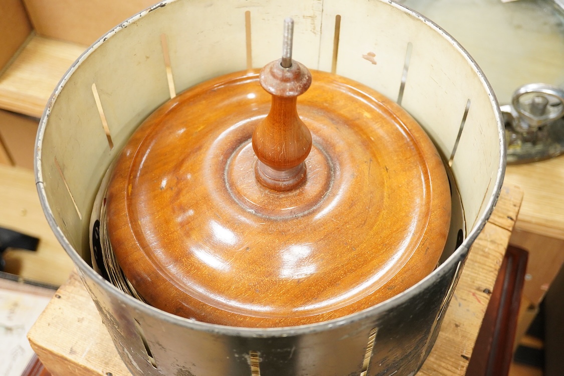 A late 19th century painted tin and mahogany zoetrope by the London Stereoscopic Co. with a number of paper inserts, diameter 30cm